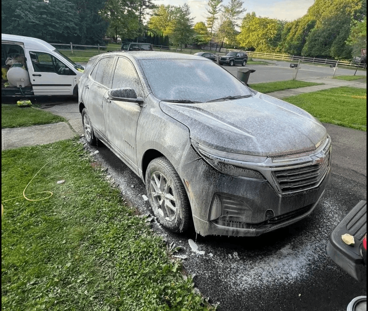 Chevy Equinox covered in soap foam mid-wash during a Flawless mobile detail at a client's home