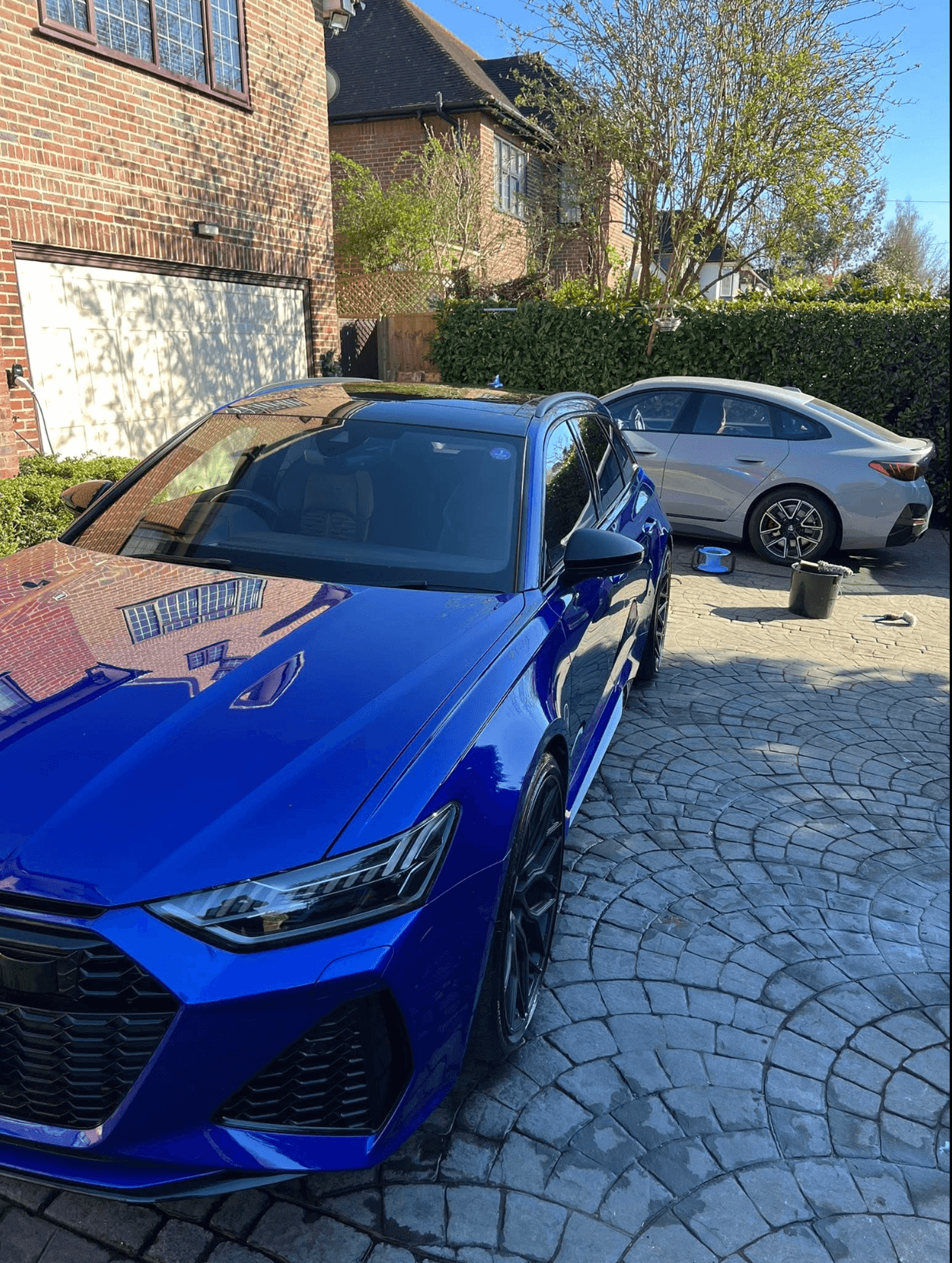 Blue Audi RS6 finished and shining in a residential driveway after a Flawless mobile detail